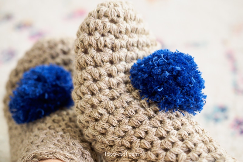 fluffy blue pompoms on crochet slippers